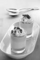strawberry caramel dessert with broken chocolate and whipped cream in a shot gass