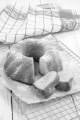 home baked gugelhupf with powdered sugar on brown paper and tea towel in the background
