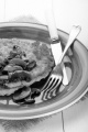 potato pancake with mushroom, onion, parsley and sauce on a blue plate