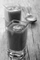 tomato soup with sour cream in a shot glass on rustic wood