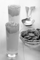 apricot compote with organic yogurt in a shot glass and cereals in a small bowl