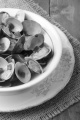 cooked clams in wine sauce with spring onion in a bowl