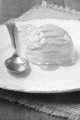 vanilla yogurt ice cream with acacia honey and spoon on a plate