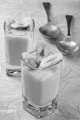 vanilla pudding dessert with dried banana slices in a shot glass