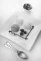 ice cream with fresh raspberries and fruit sauce on a plate