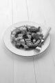 fresh vegetarian salad with cucumber, tomato and rocket salad on a white plate