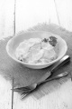 cucumber salad with sour cream and parsley in a bowl