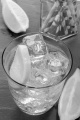 sparkling water with ice cubes and slice of lemon in a glass