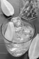 sparkling water with ice cubes and slice of lemon in a glass