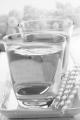 grape juice in a glass and grapes in the background