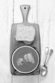 hungarian fish soup made from carp in a pot with bread on a wooden board