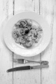fried potato, bacon, scrambled eggs and parsley on a plate