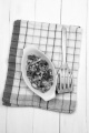 fried bacon bits with parsley in a white bowl