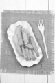 french fries on a white cardboard dish with a plastic fork