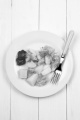 boiled potatoes with fried salmon, tomatoes and dill on a white plate
