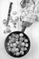 brussels sprouts with water in a pot, kitchen knife and tea towel