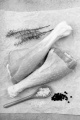 raw turkey drumsticks with thyme, pepper and coarse salt on white kitchen paper 