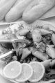 crab claw opened with a nutcracker, salad and bread roll