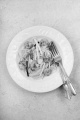 spaghetti with courgette strips, gartlic and prawns on a plate