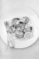 king prawn with slice lemon and cooked leek on a plate