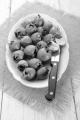 dried rosehip on a white plate with knife