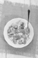 vegetable pasta salad with carrot, pea, lilac onion, egg, parsley and sweet corn in a bowl on jute