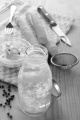 home made elderflower vinegar and sour vegetable with peppercorn and carrot, kitchen towel, knife and sieve