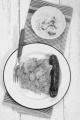 pasta and potato with paprika powder, kolbasz,  on enamel plate and sour vegetable in a white bowl