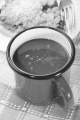 hot chocolate in a red enamel mug and cherry crumble with fork on plate