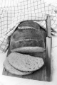 sliced warm bread loaf on a wooden board with knife